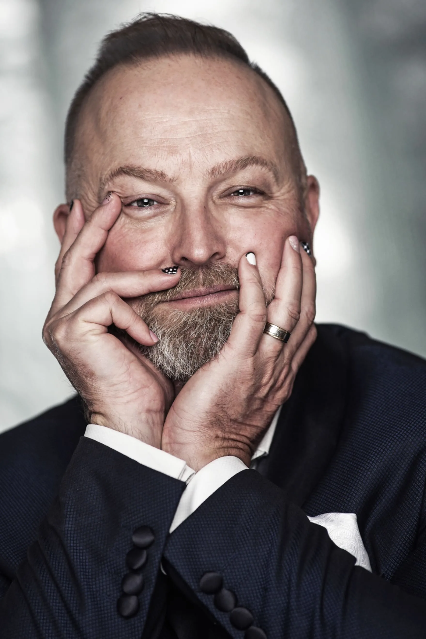 Michael Bach, sitting with his head in his hands, facing the camera.